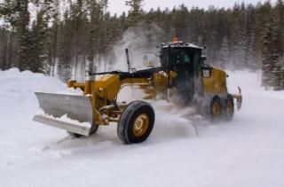 grader plowing snow